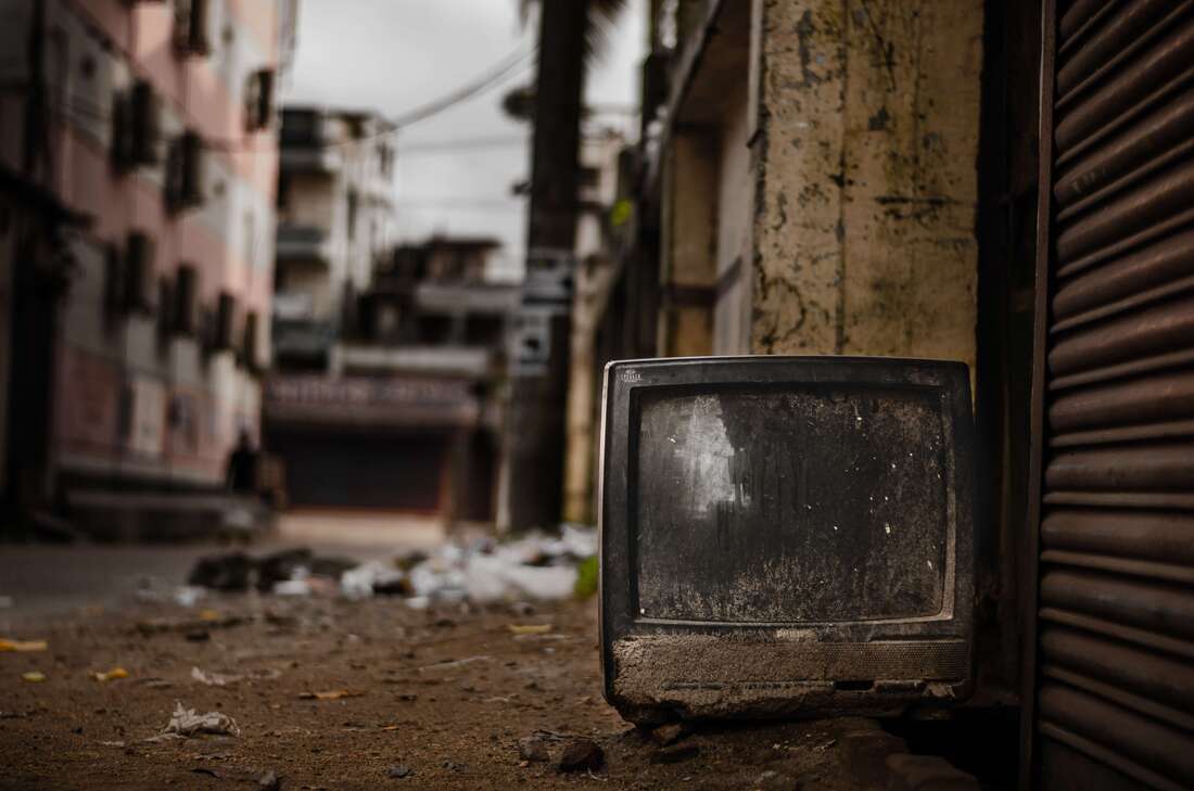 Broken TV in alley